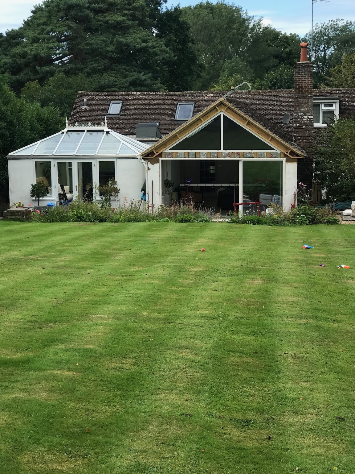 Full property and garden view showing the scale of the bungalow transformation